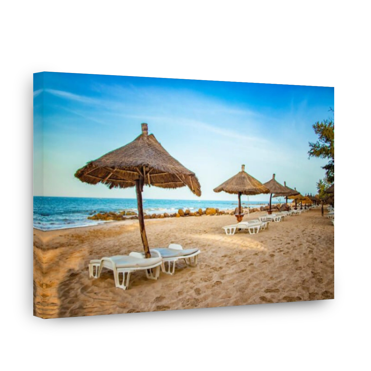 Pair of sunbed with parasol on beautiful empty beach near clear sea. It is a tropical paradise in Africa, Senegal. There is blue sky. It is the right