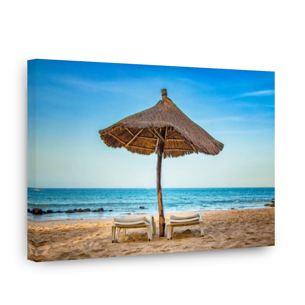 Pair of sunbed with parasol on beautiful empty beach near clear sea. It is a tropical paradise in Africa, Senegal. There is blue sky. It is the right