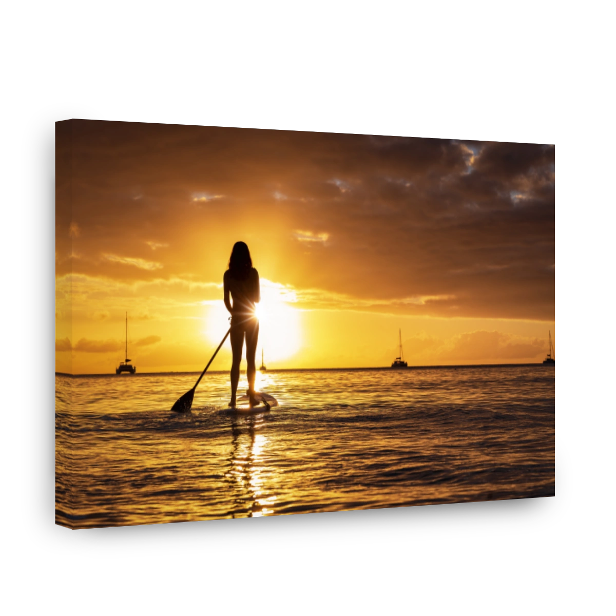 Silhouette of a woman on a stand up paddle board during sunset