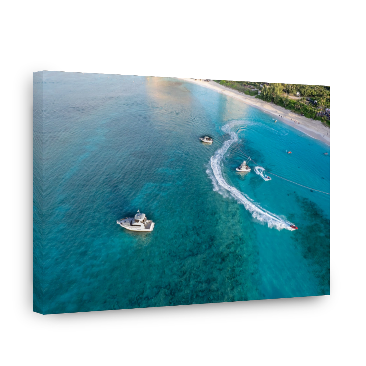 Drone aerial view of jet ski and boat sailing next to Cove beach, Paradise Island, Nassau.