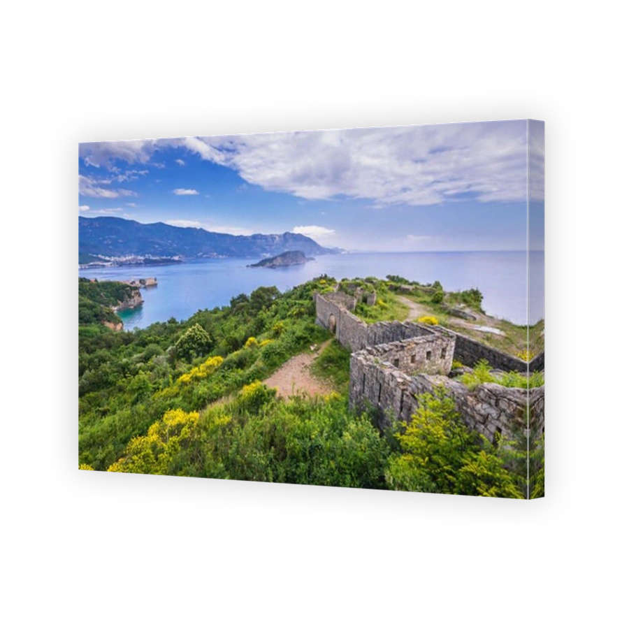Ruins of 19th century Austrian Mogren Fortress in Budva city on the Adriatic Sea coast in Montenegro. Aerial view with Sveti Nikola Island