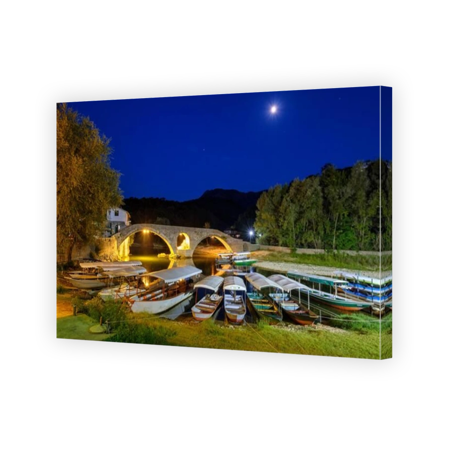 Excursion boats and Old Bridge Stari most at dusk, river Crnojevic, Rijeka Crnojevica, national park Lake Skadar