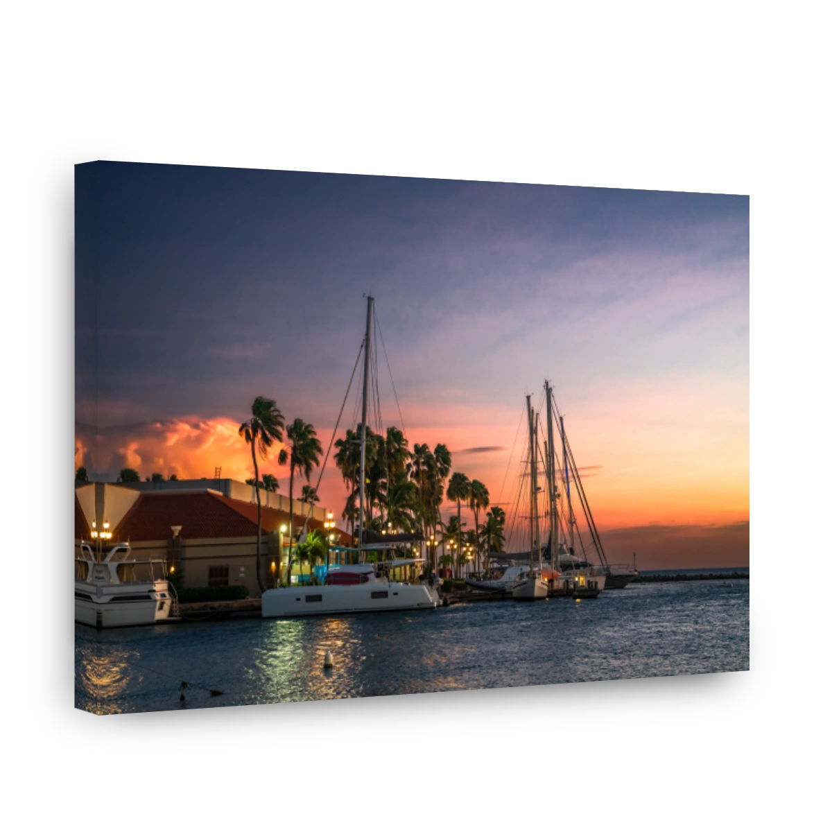 Oranjestad Aruba seen at sunset with boats, ocean and palm trees