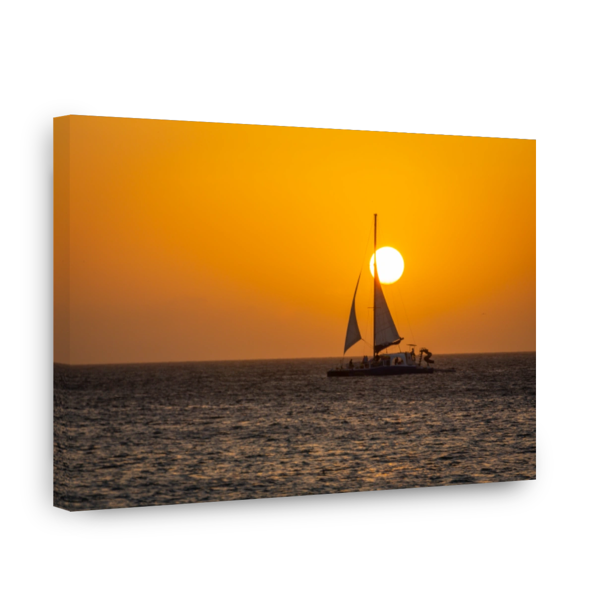 Idyllic beach with sailboat in Aruba at golden sunset, Dutch Antilles