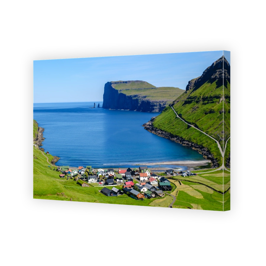 Stunning coastal view of a colorful village in the Faroe Islands nestled among green hills