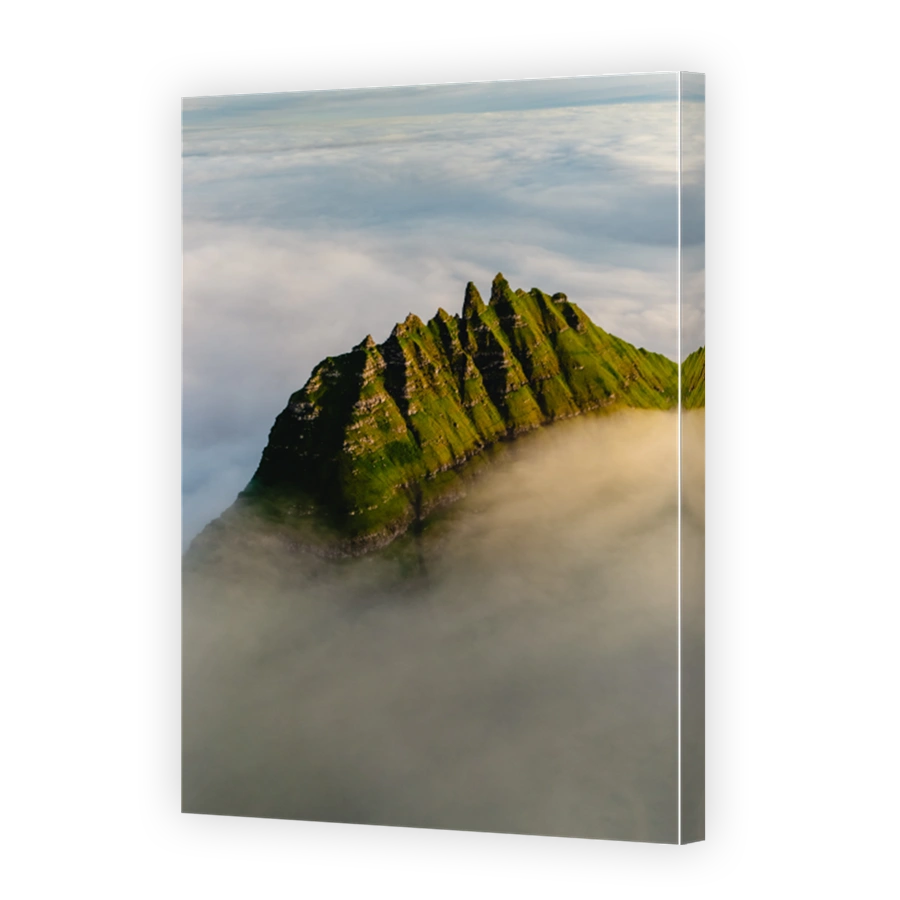 Majestic cliffs rise above the clouds in the spectacular Faroe Islands landscape