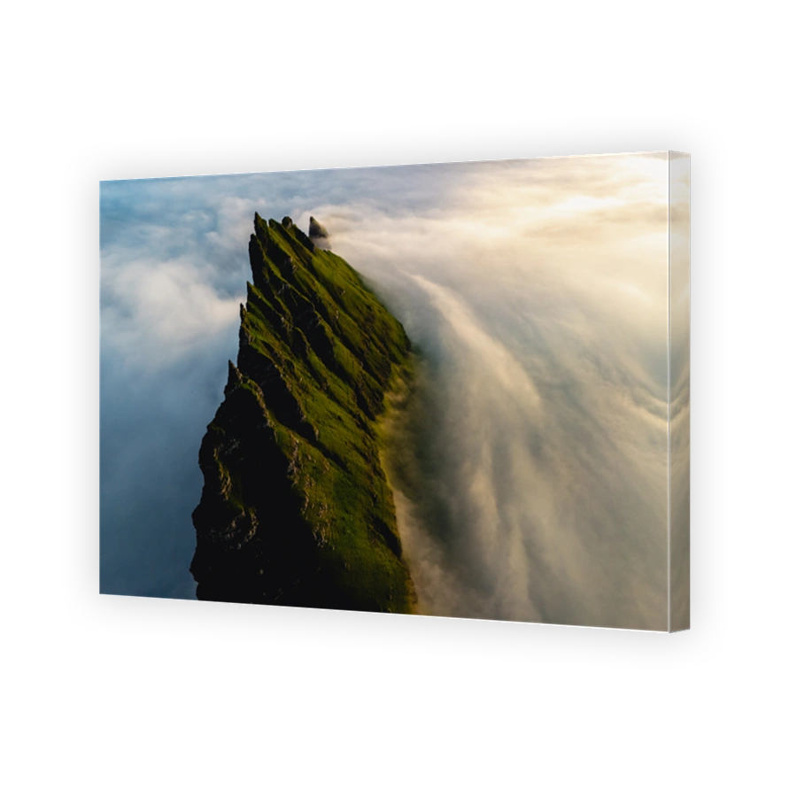Majestic cliffs rise above a sea of clouds in the enchanting Faroe Islands landscape
