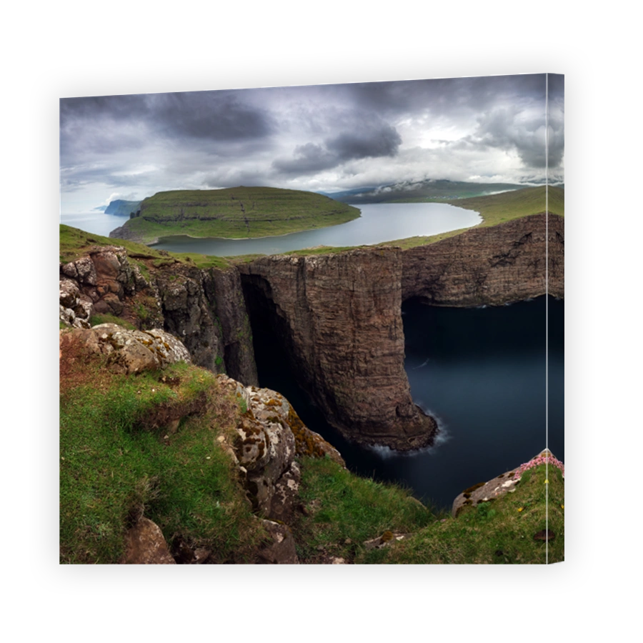 Faroe Islands landscape- Hike to the Traelanipa Slave Cliff near Leitisvatn Lake with steep drops into the ocean, Denmark.