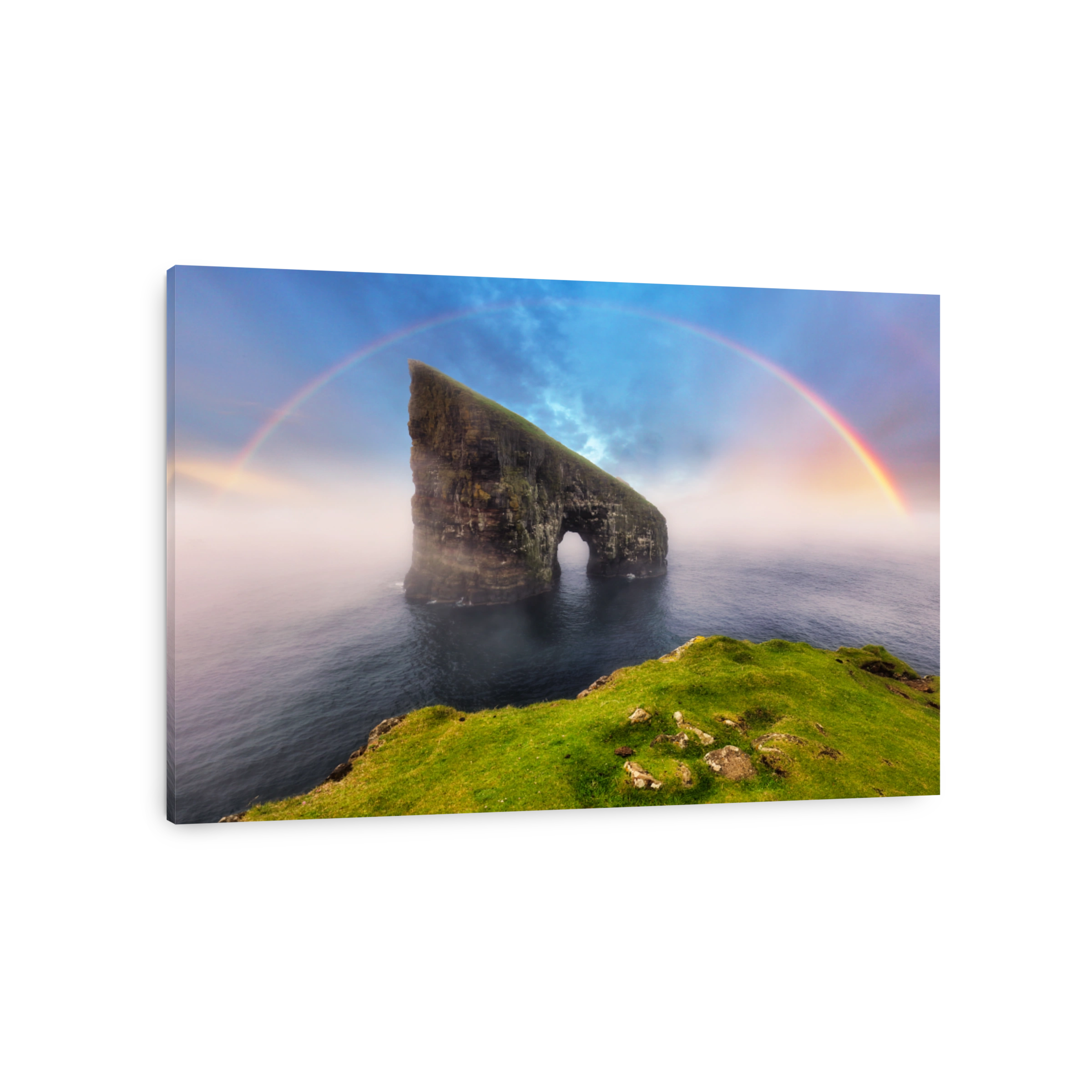 Rainbow over coast cliff in ocean Drangarnir in Faroe island. Sunset landscape