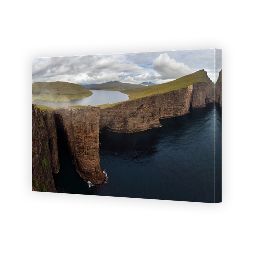 Faroe Islands landscape- Hike to the Traelanipa Slave Cliff near Leitisvatn Lake with steep drops into the ocean, Denmark.