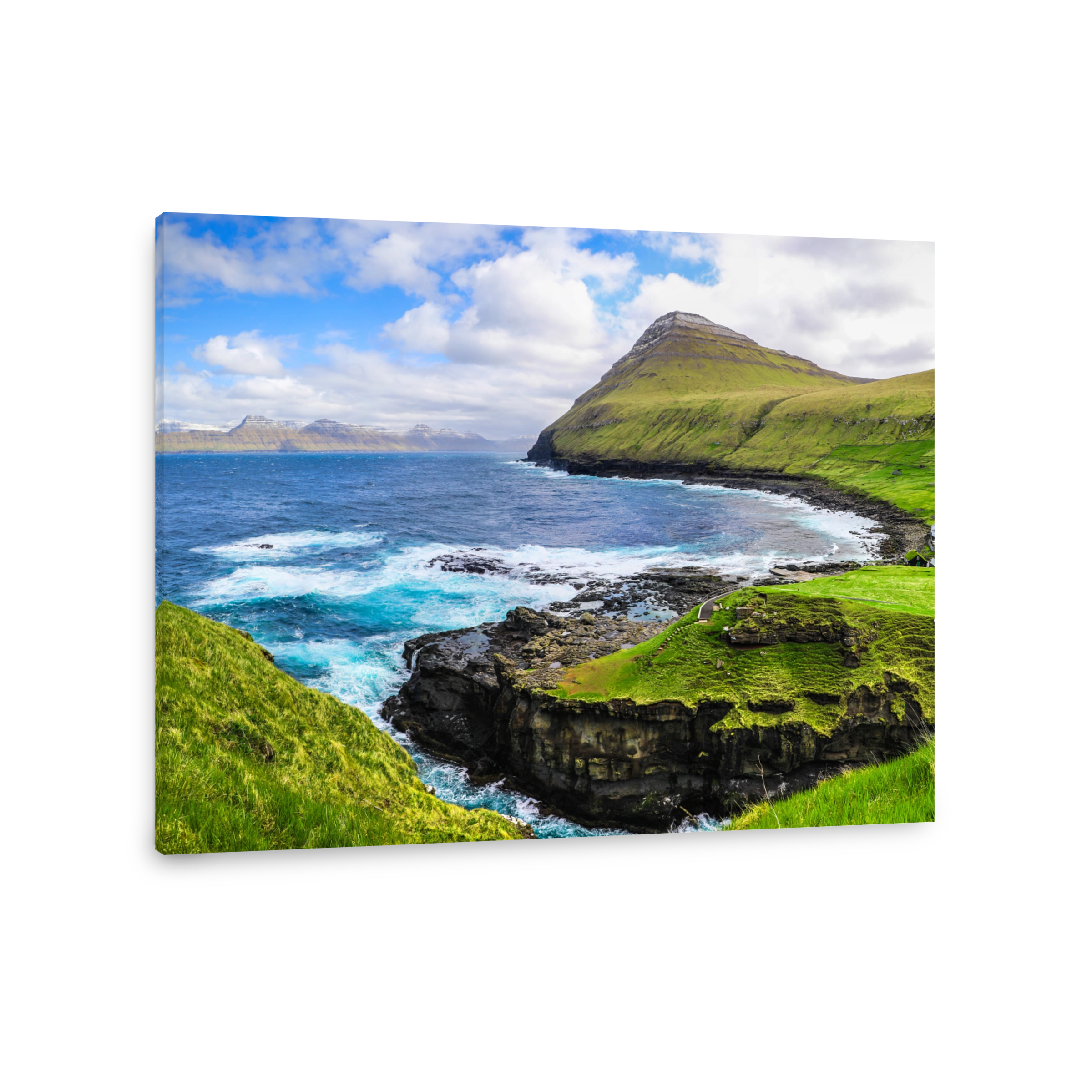 Dramatic crashing waves and green hillside of Gjogv in the Faroe Islands