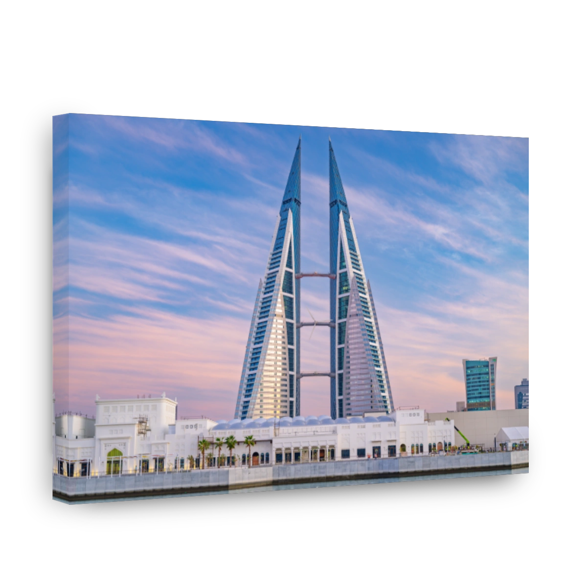 Bahrain World Trade Center A modern skyscraper stands tall against a vibrant blue and pink sky in an urban cityscape