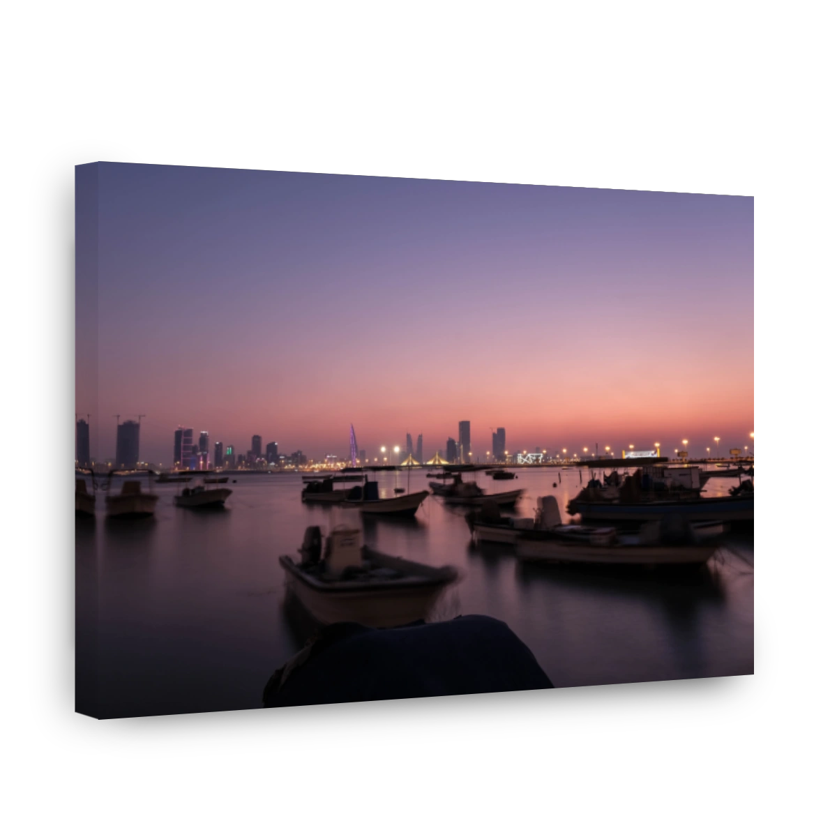 River By Illuminated City Against Clear Sky During Sunset