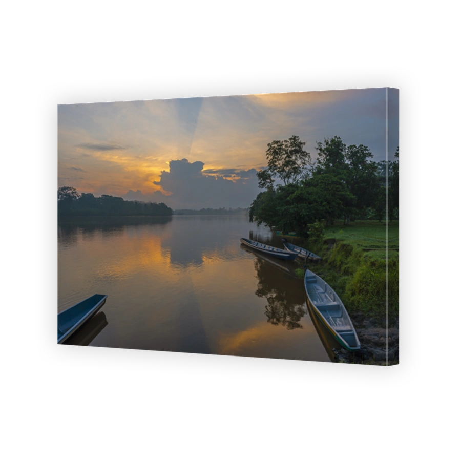 Amazon river rainforest sunrise with canoes