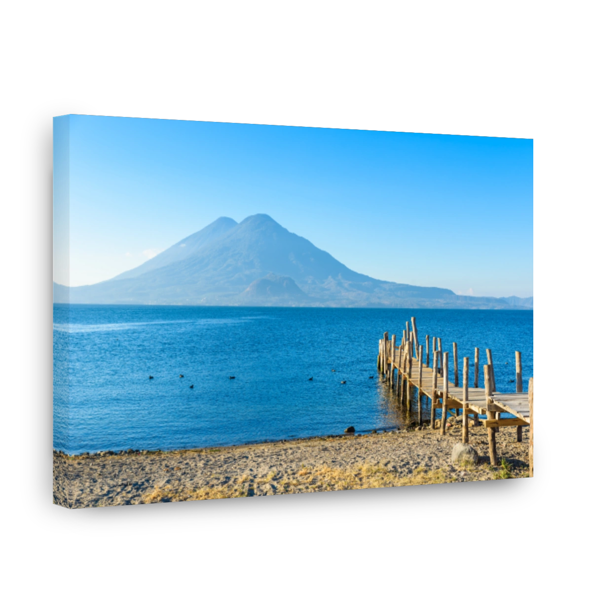 Wooden pier at Lake Atitlan on the beach in Panajachel, Guatemala.  With beautiful landscape scenery of volcanoes Toliman, Atitlan and San Pedro in the background.