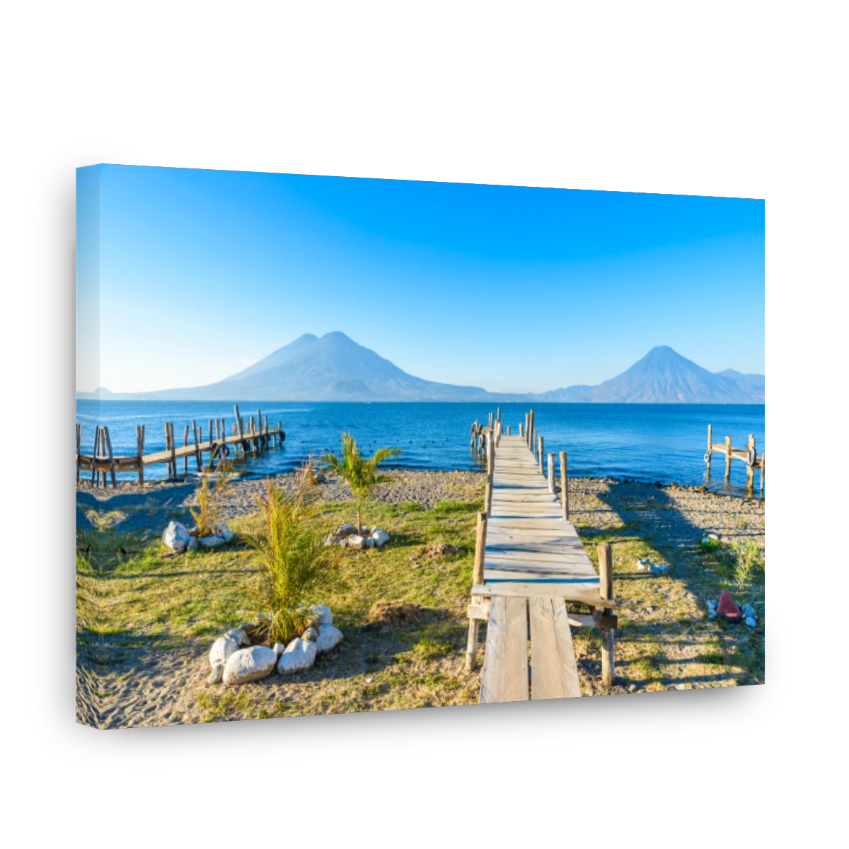 Wooden pier at Lake Atitlan on the beach in Panajachel, Guatemala.  With beautiful landscape scenery of volcanoes Toliman, Atitlan and San Pedro in the background.