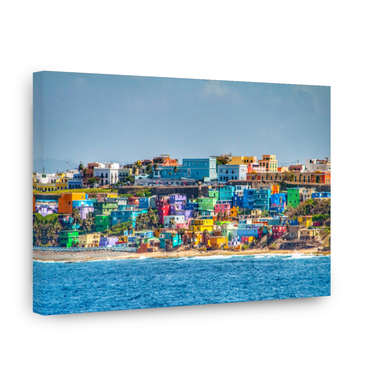 Bright colorful houses line the hills overlooking the beach in San Juan, Puerto Rico