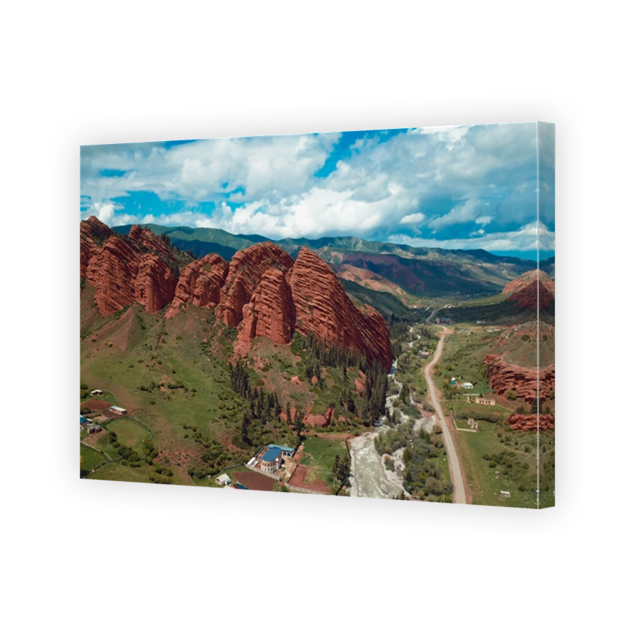 Kyrgyzstans red mountains and winding river under a bright sky create a stunning landscape