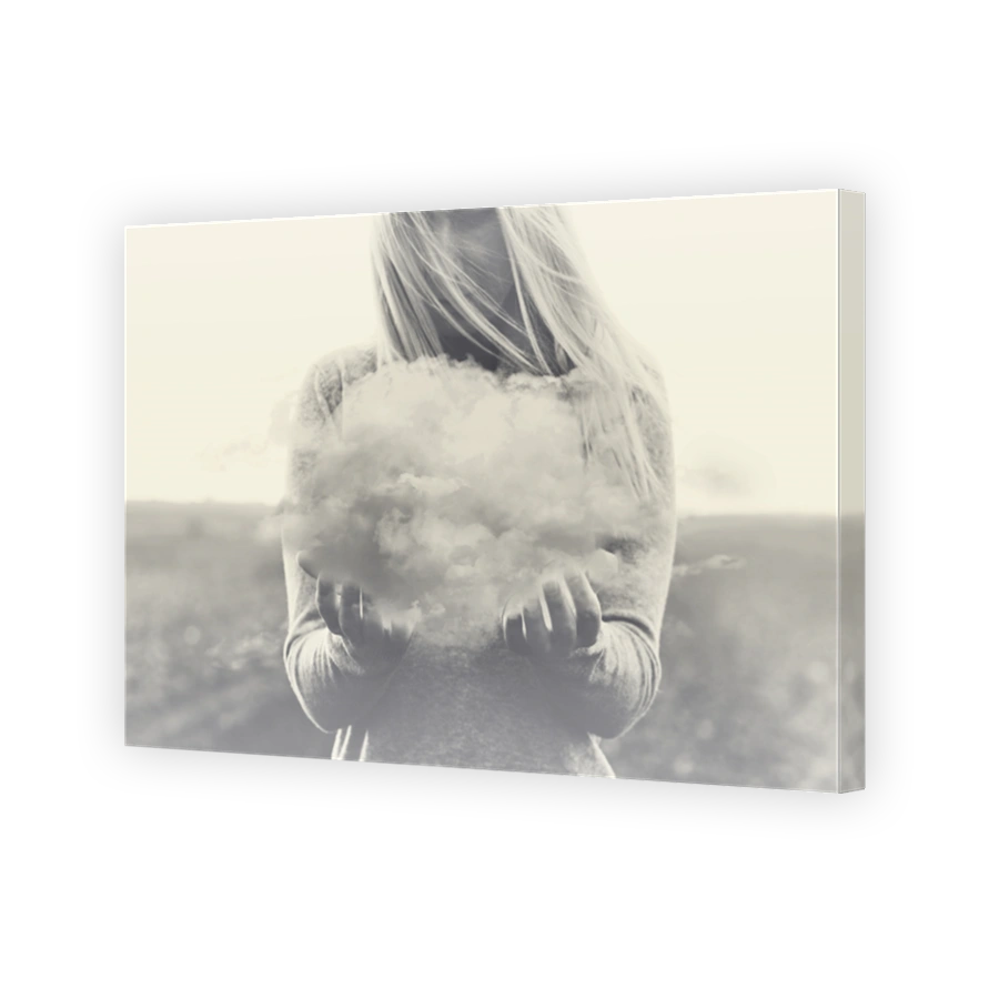 Surreal moment, solitary woman holding in her hands a gray cloud
