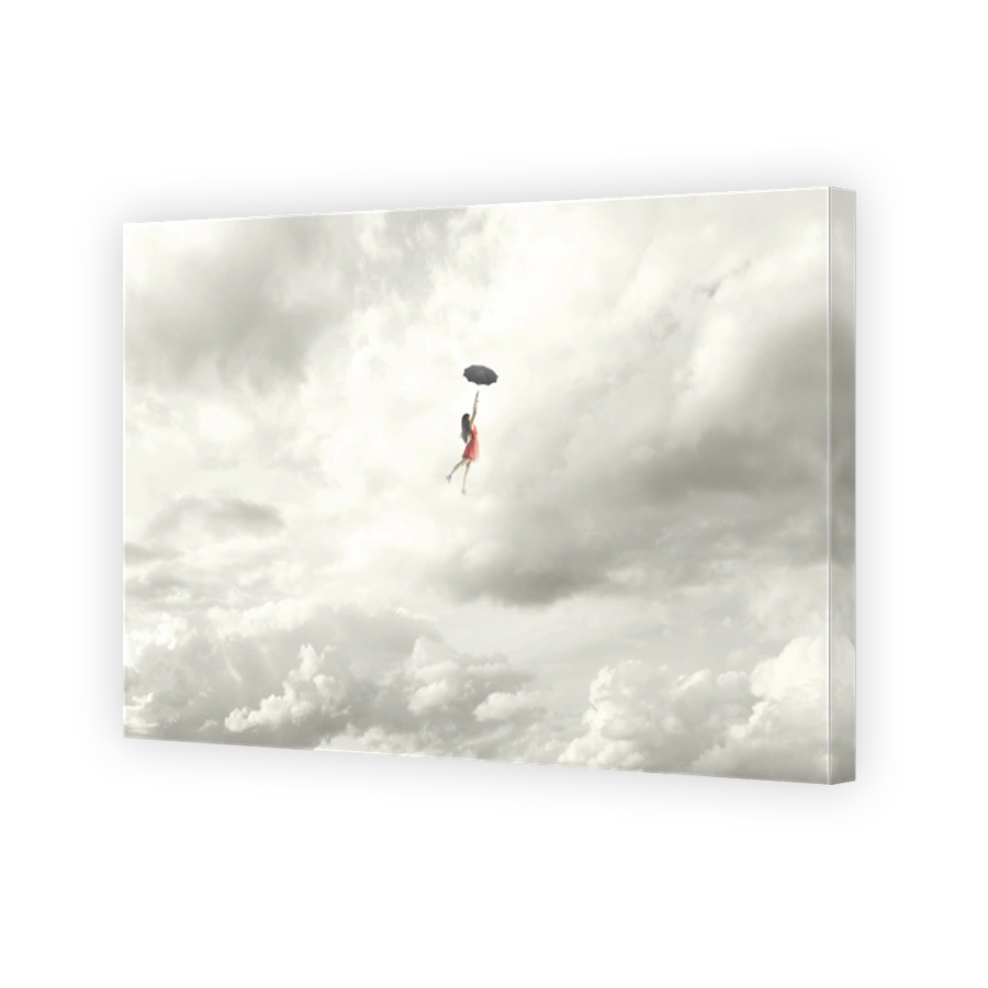 Surreal moment of an elegant woman flying in the middle of the clouds hanging on her umbrella