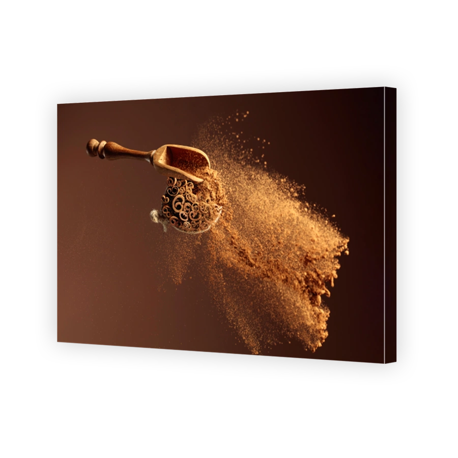 Cinnamon powder is poured out of the wooden spoon.