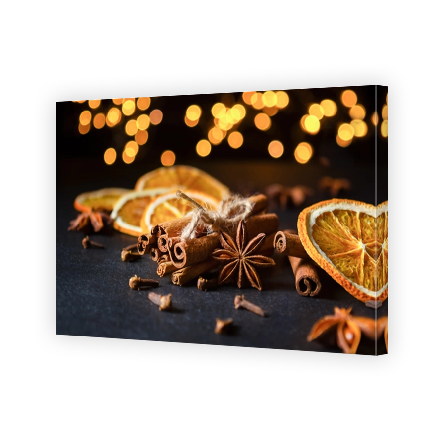 Cinnamon sticks, star anise, cloves and dried orange slices with defocused lights