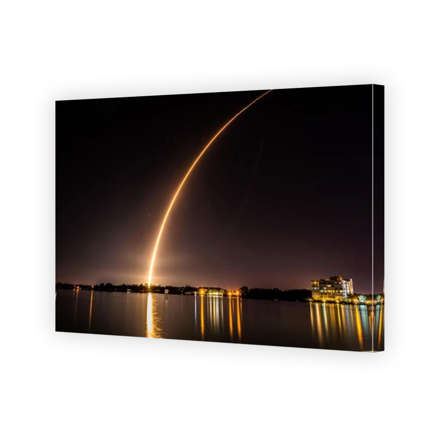 An Atlas V rocket streaks through the night sky, seen from Merritt Island Florida.