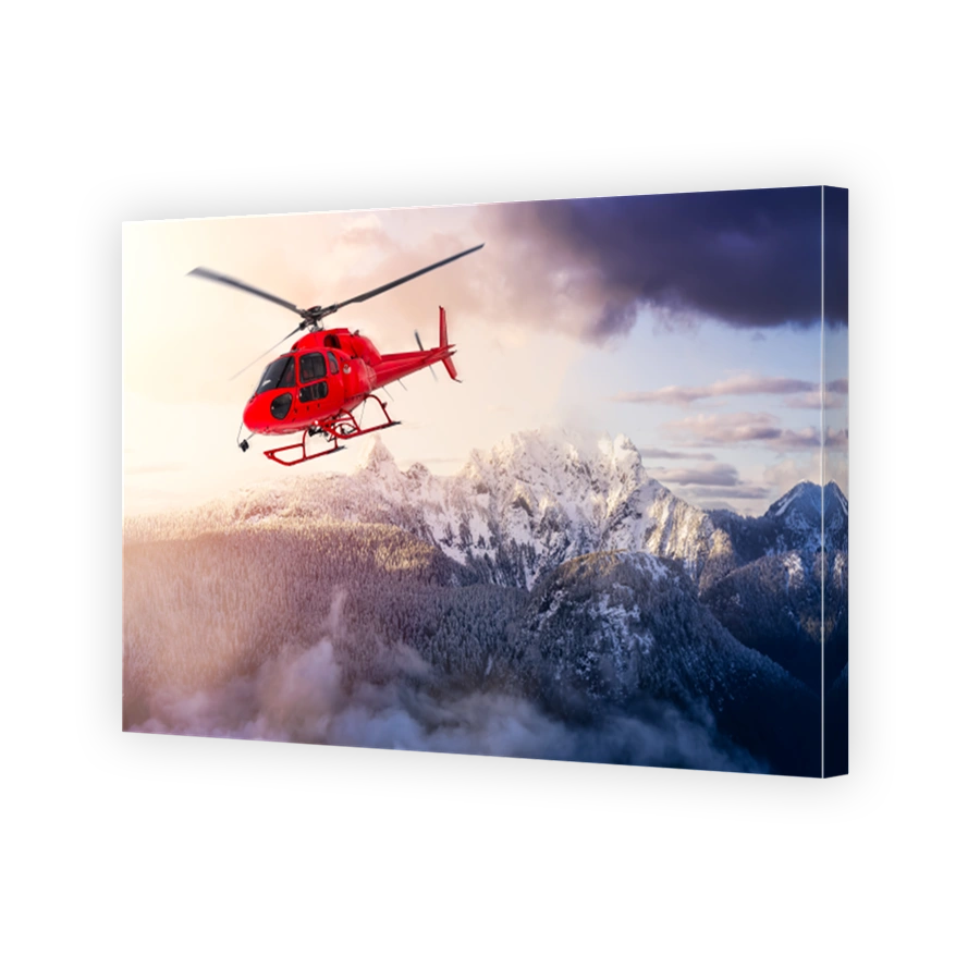 Red Color Helicopter flying over the Rocky Mountains