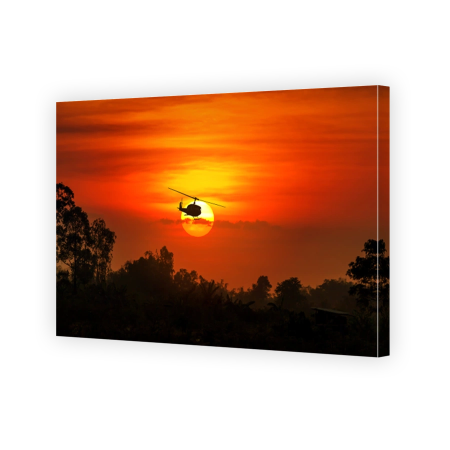 silhouette of helicopter with sunset