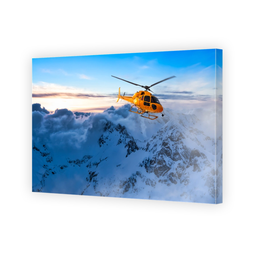Yellow Helicopter flying over the Rocky Mountains