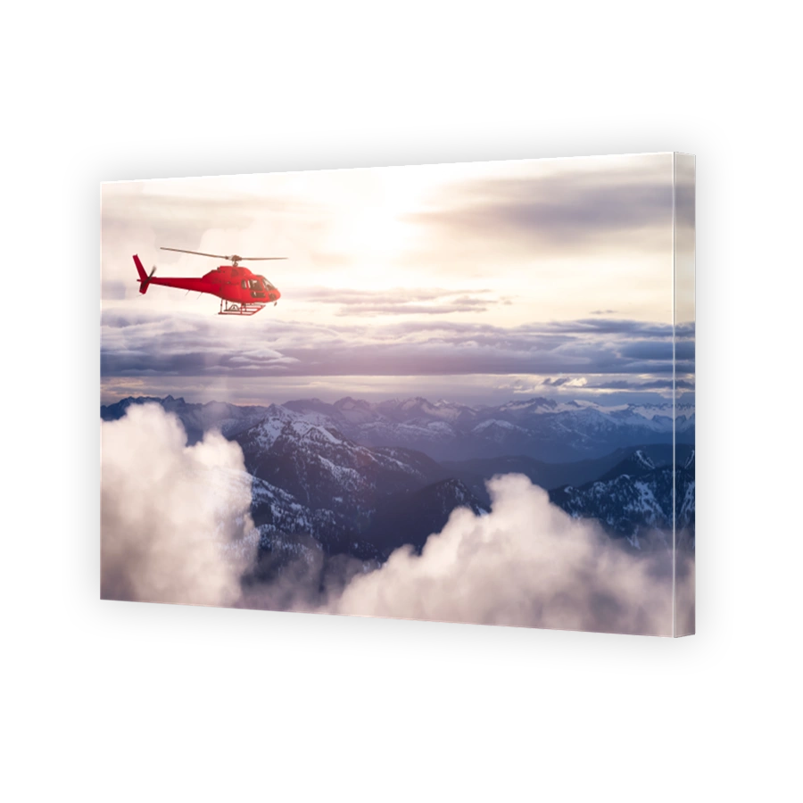 Red Color Helicopter flying over the Rocky Mountains