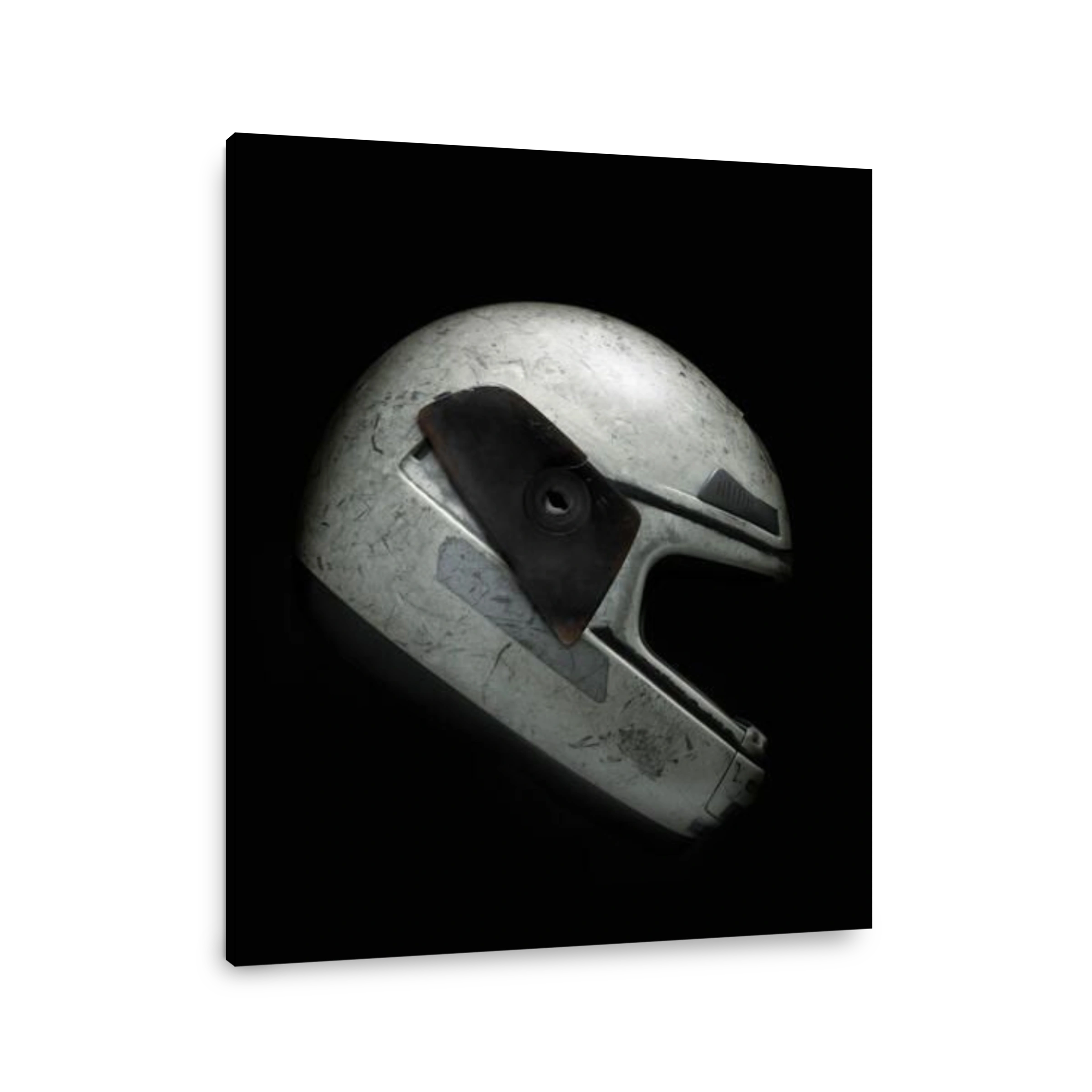 Broken and scratched motorcycle helmet against black background. Clipping path.