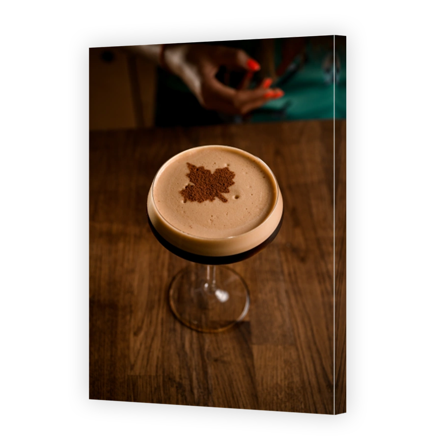 high angle view of glass of frothy drink decorated by cocoa powder in leaf pattern