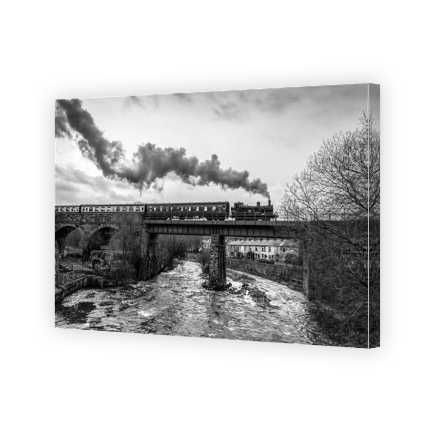 Tank engine puffs along on the East Lancashire railway. ELR. Brooksbottom viaduct over the river Irwell.