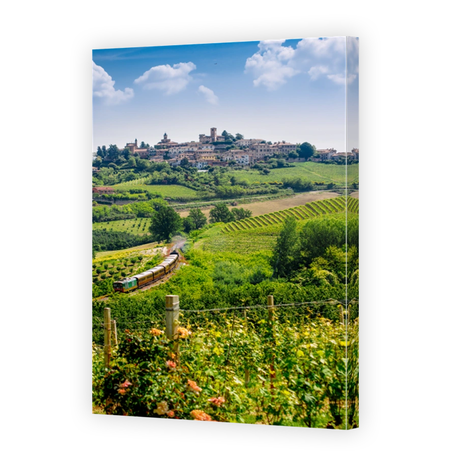 The Town Of Neive,  In Italy Surrounded By Hills With A Historic Train In Transit