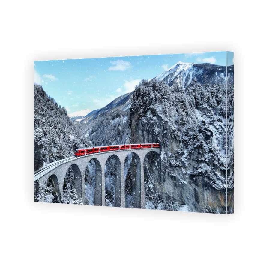 Snow falling and Train passing through famous mountain in Filisur, Switzerland. Train express in Swiss Alps snow winter scenery.