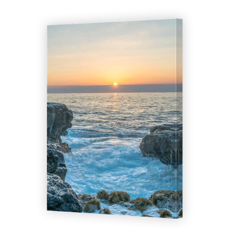 Sunrise over rock formations on beach