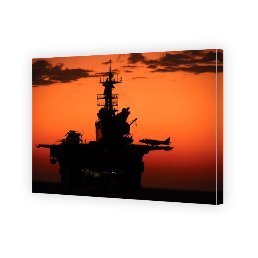 The setting sun silhouettes the amphibious assault ship USS Makin Island.