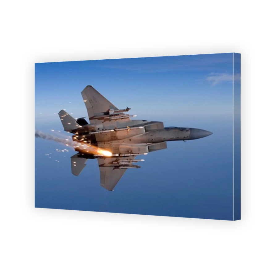 An F-15 Eagle releases a flare while breaking hard to the left.