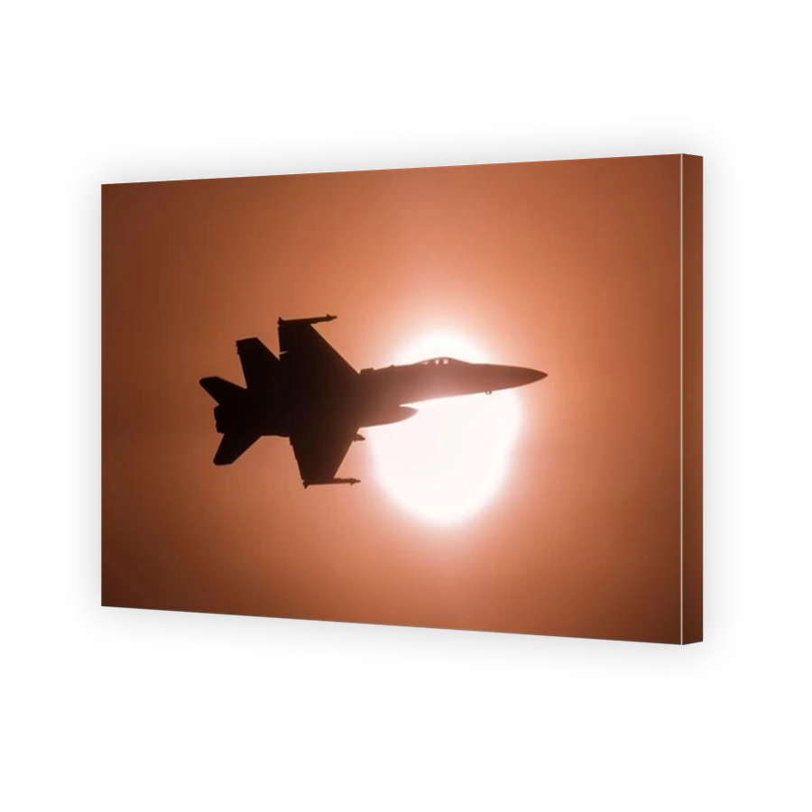Finnish Air Force F-18C jet flying past the bright sun.