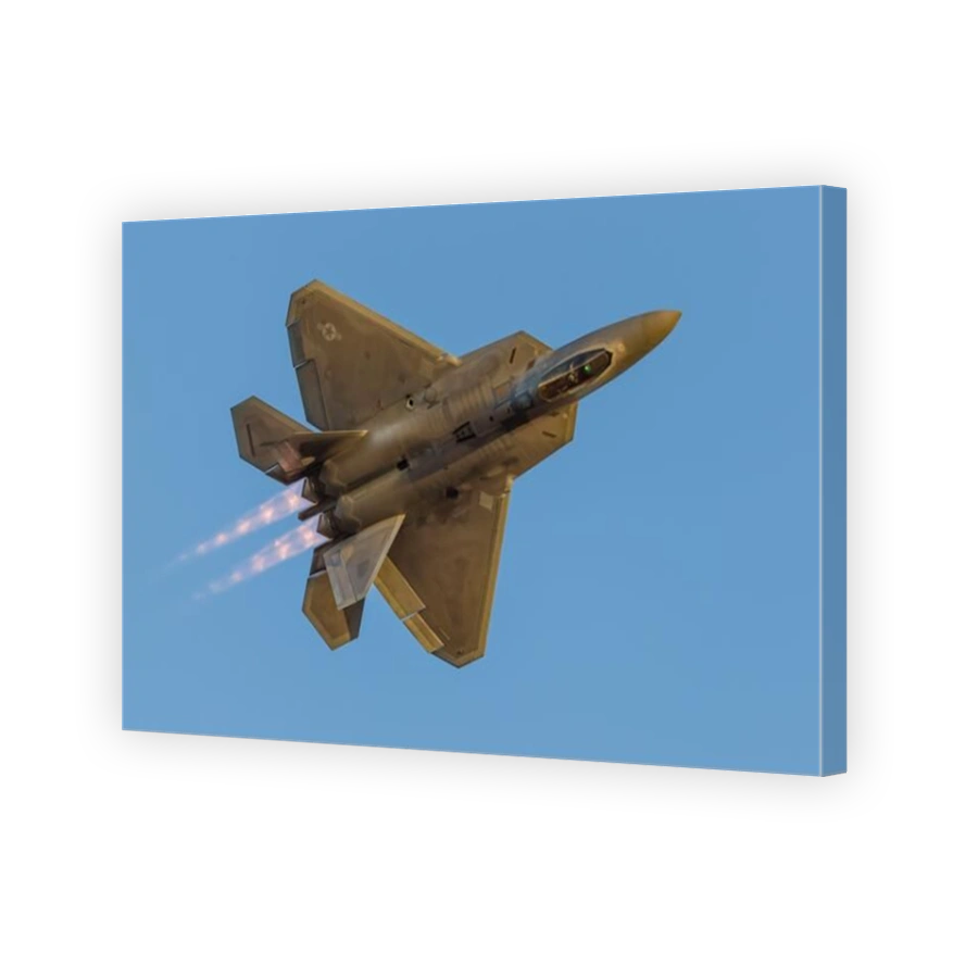 A U.S. Air Force F-22A Raptor pulls a turn just before sunset.