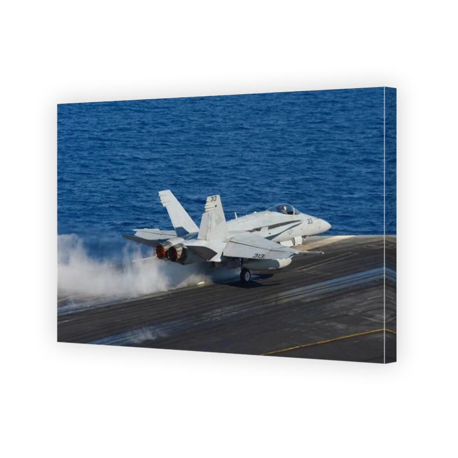 Mediterranean Sea, October 23, 2013 - An F/A-18C Hornet launches from the flight deck of the aircraft carrier USS Nimitz (CVN 68