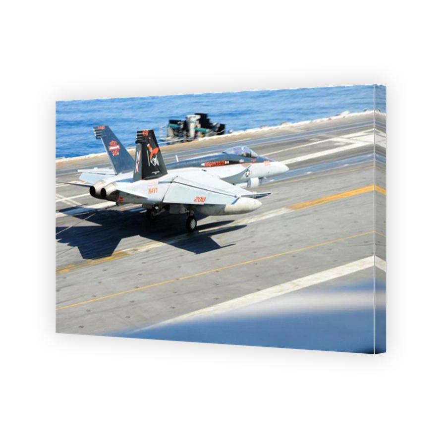 An F/A-18E Super Hornet lands aboard the aircraft carrier USS Ronald Reagan