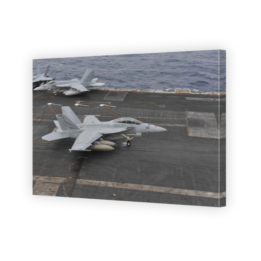 South China Sea, November 23, 2013 - An F/A-18F Super Hornet lands on the flight deck aboard the aircraft carrier USS Nimitz (CV