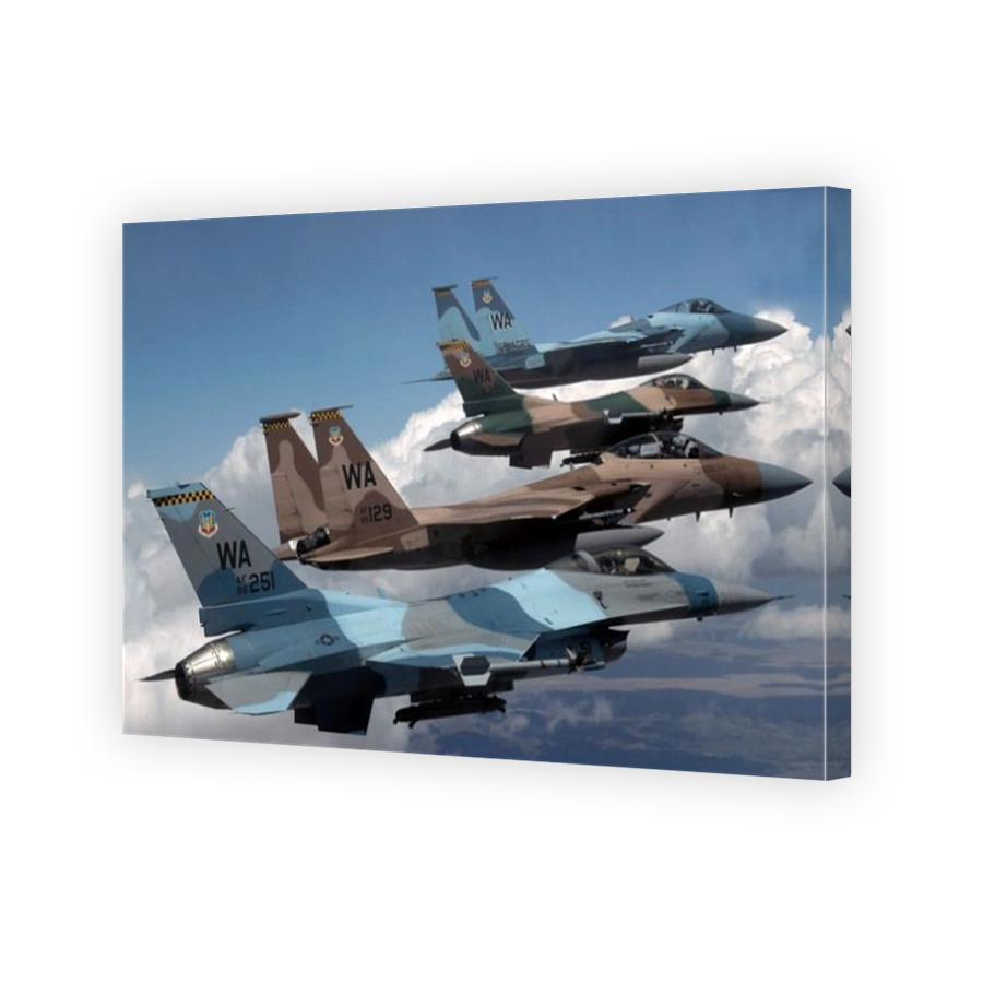 A flight of Aggressor F-15 and F-16 aircraft fly in formation.