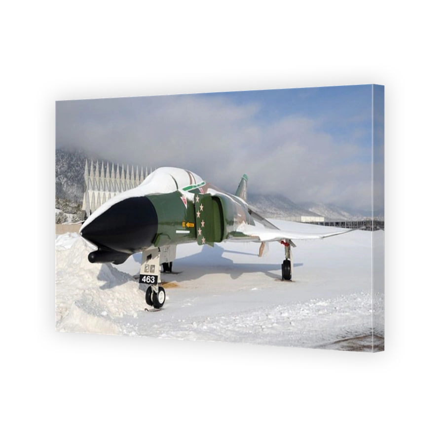 An F-4D Phantom II aircraft static display covered in snow.