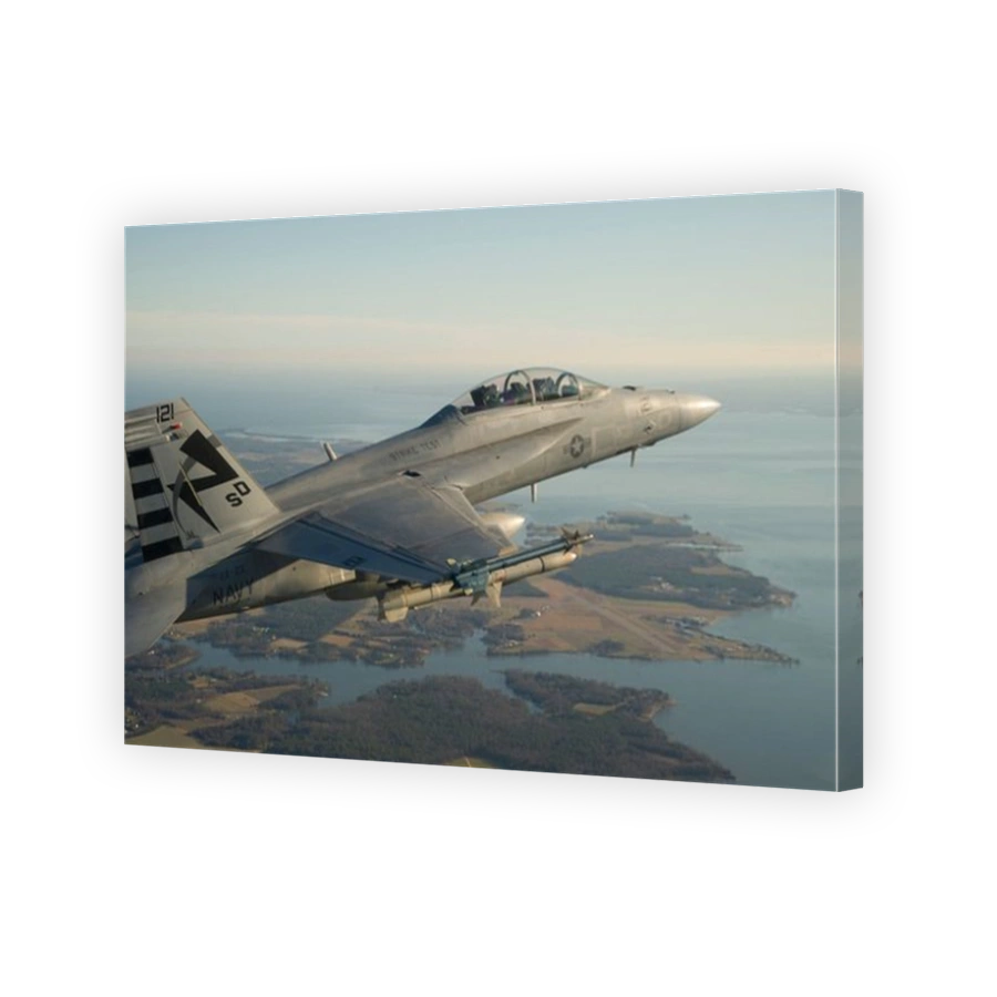 An F/A-18F Super Hornet conducts a captive carry flight test of an AGM-88E Advanced Anti-Radiation Guided Missile.