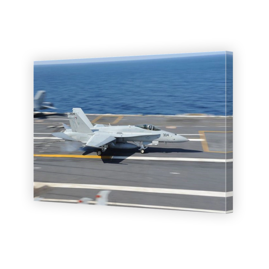 An F/A-18C Hornet lands aboard USS George H.W. Bush.