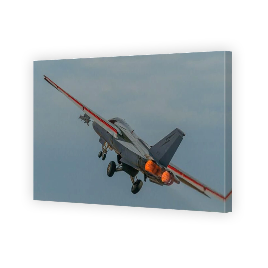 A rear end frame of a Royal Australian Air Force F-111C 'Pig' or 'Aardvark' pulling away from the camera with full afterburners glowing.