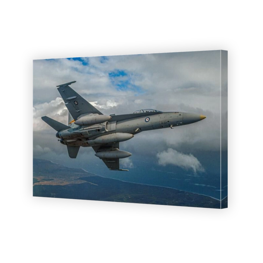 An air to air shot of an RAAF, two seat, McDonnell Douglas (now Boeing) F/A18 Hornet jet fighter banking.